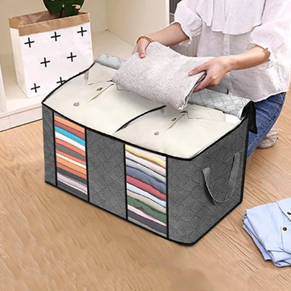 Gray quilt storage bag with shirts inside.