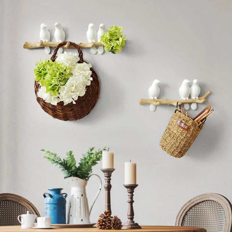 White resin bird wallhanger set, each holding a basket.