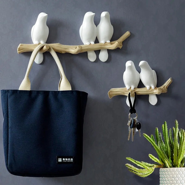 White resin bird wall hanger set. A triple hook set with 3 birds and a double hook set iwth 2 birds.